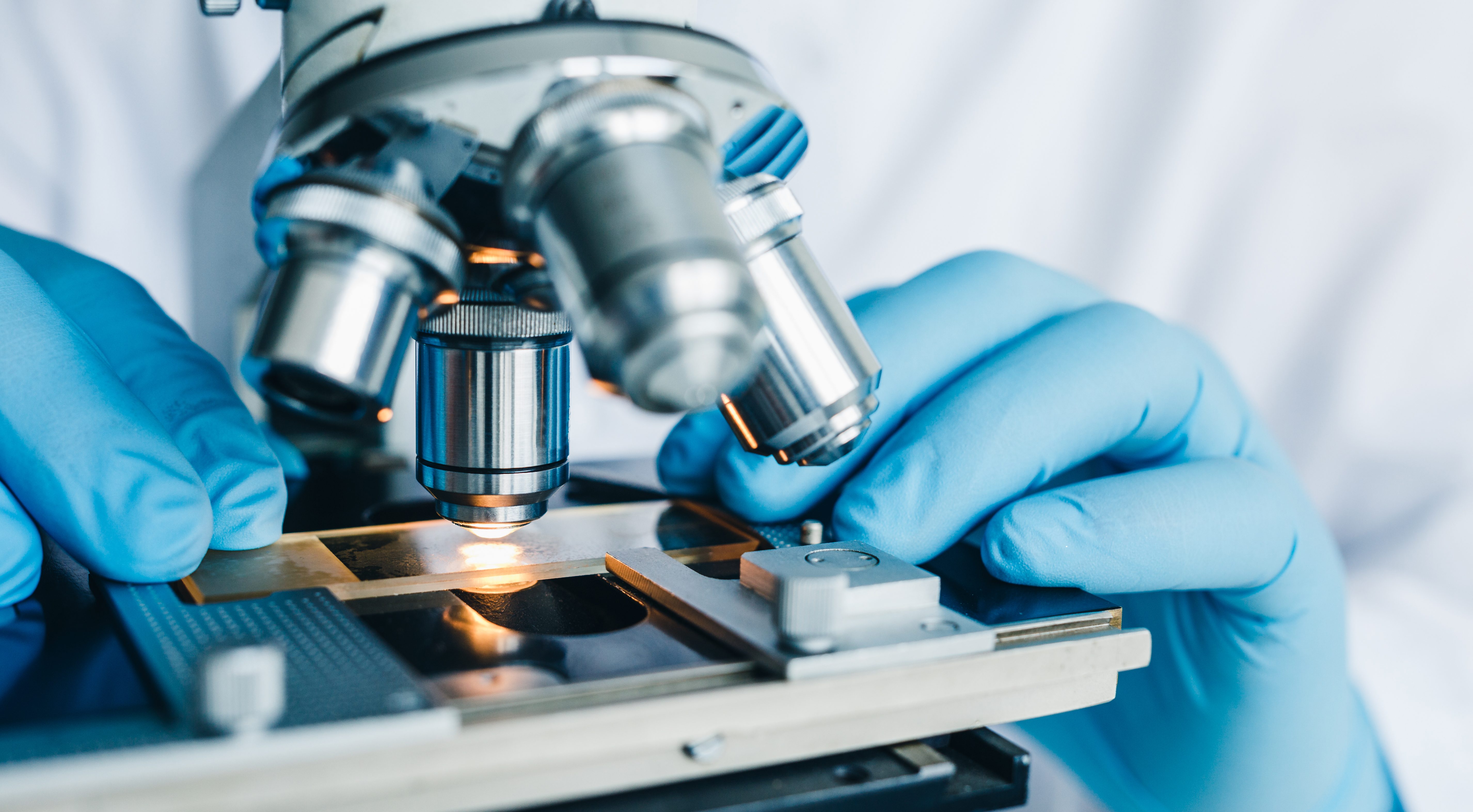 Close-up shot of microscope with metal lens at laboratory.